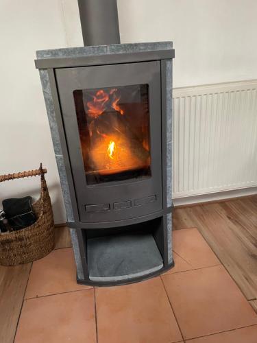 a wood stove in the corner of a room at The Old Barn in Hoevelaken