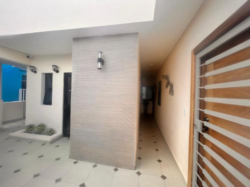 a hallway with a pivot door in a house at El descanso in Higuey