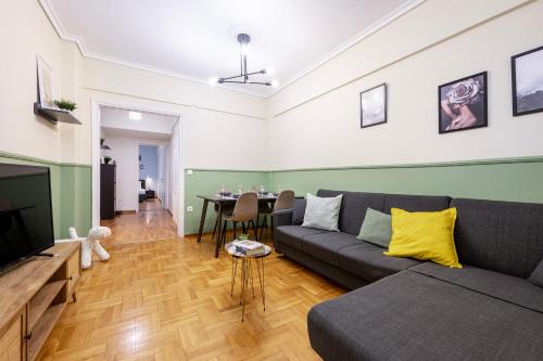 a living room with a couch and a table at Houseloft CityView Hagia Sophia in Thessaloniki