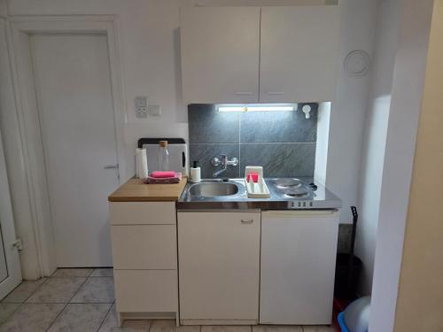 a small kitchen with a sink and a counter at Villa Bianca in Baška