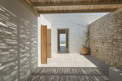 a hallway of a house with a brick wall at Villa Anelya in Parikia