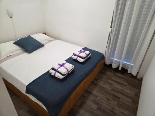a bedroom with a bed with two towels on it at Villa Bianca in Baška