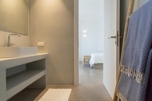 a bathroom with a sink and a mirror at Villa Anelya in Parikia