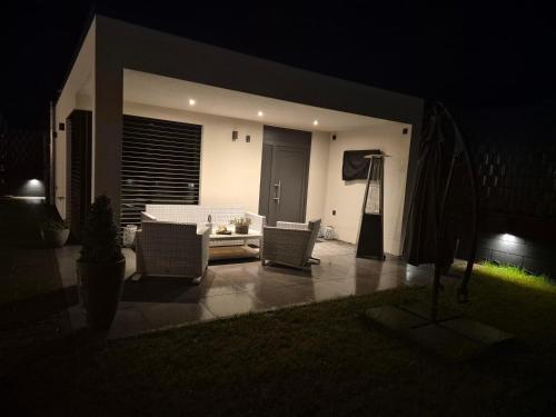 a patio with chairs and a table at night at Apartment Timeout in Welschbillig