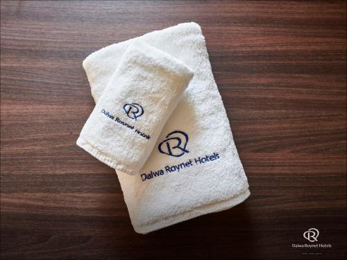 a towel sitting on a table with two hearts on it at Daiwa Roynet Hotel Kawasaki in Kawasaki