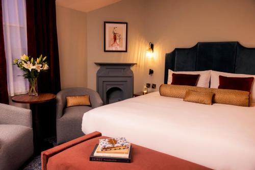 a hotel room with a bed and a fireplace at The Royal Bell in Bromley