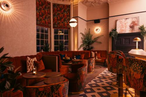 a lobby with couches and tables and windows at The Royal Bell in Bromley