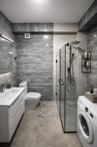 a bathroom with a toilet sink and a washing machine at Relax Apartments in Crystal Residence Bakuriani in Bakuriani