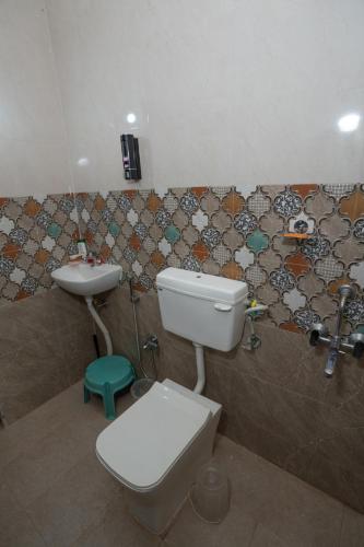a bathroom with a toilet and a sink at Swara Villa Your Perfect Getaway in Jāmb
