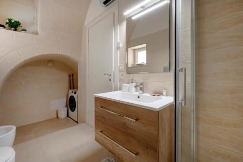 a bathroom with a sink and a shower and a toilet at Ranieri rooms & relax Mare in Mola di Bari