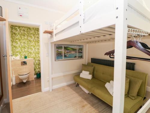 a living room with a couch and a loft bed at Kirkham House in Matlock