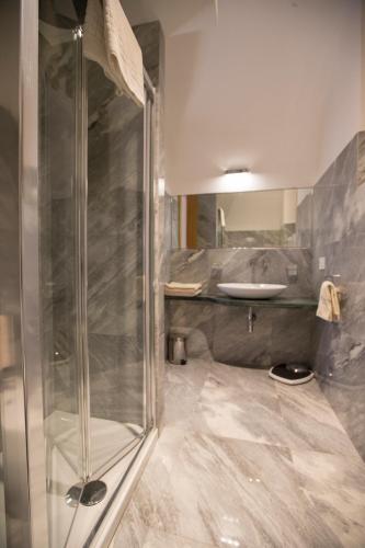 a bathroom with a shower and a sink at Palazzo Tronconi agriturismo in Arce