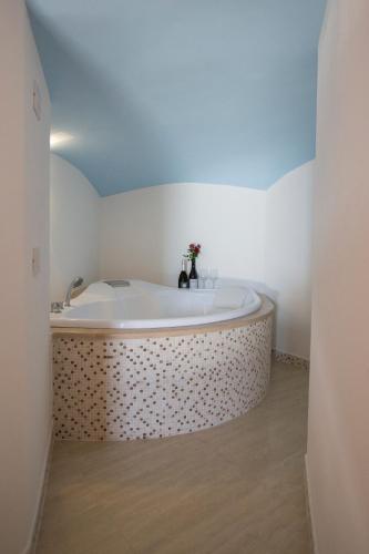 a bathroom with a large tub in a room at Palazzo Tronconi agriturismo in Arce