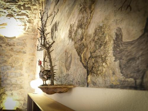 a wall with a painting of a chicken and a lamp at DONNAPAOLA MODERN FARM in Altamura
