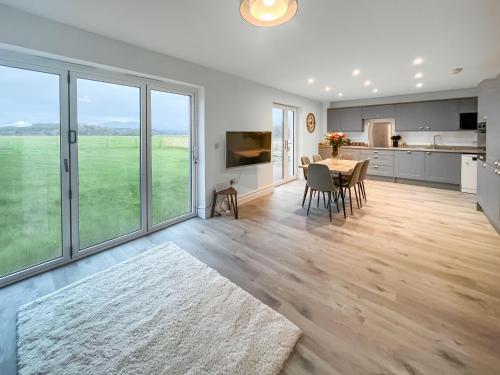 a kitchen and dining room with a table and chairs at Eriska View in Port Appin