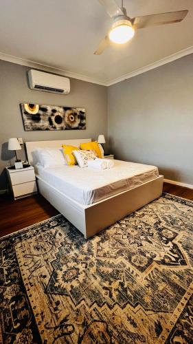 a bedroom with a large bed and a rug at Perth Airport 2 Bedroom duplex unit not apartment in Perth