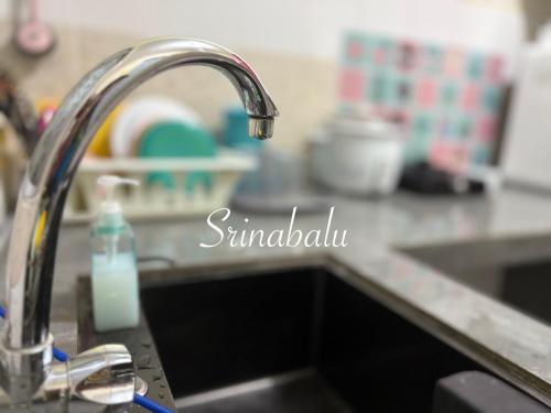 a kitchen sink with a bottle of soap on it at Sri Nabalu Apartment Platinum Putatan in Kota Kinabalu