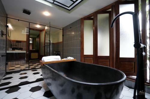 a bathroom with a large tub and a shower at Seascape Beach Retreat in Kannur
