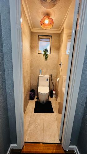 a bathroom with a white toilet and a window at Perth Airport 2 Bedroom duplex unit not apartment in Perth