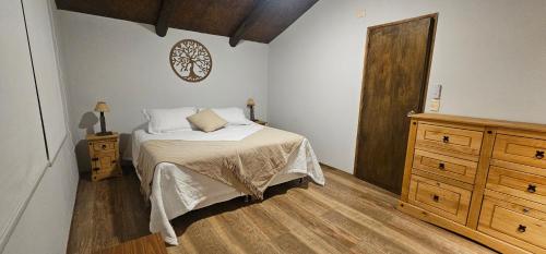 a bedroom with a bed and a wooden door at Morada La Granja in Minas