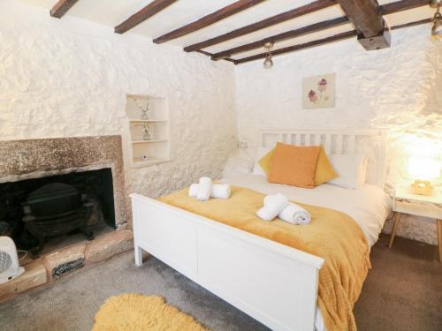 a bedroom with a bed and a fireplace at Roseville in Matlock