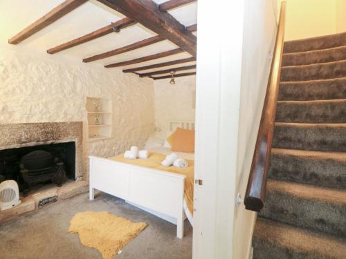 a living room with a fireplace and a staircase at Roseville in Matlock