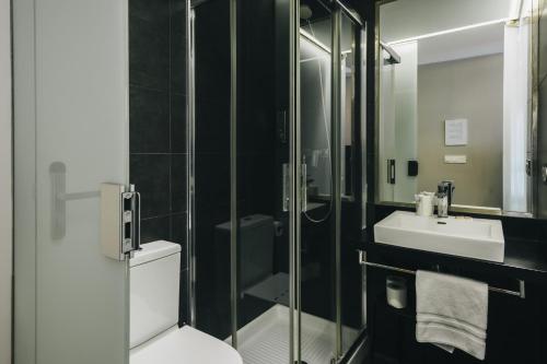 a bathroom with a toilet and a sink at Pension Ondarra Autocheck-In in San Sebastián