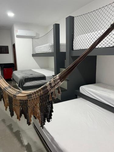 a room with two bunk beds and a hammock at Apartamento Zion reserve suites in Conde