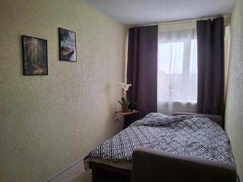 a bedroom with a bed and a window at Kalda tee Apartment - self chech-in, free parking in Tartu