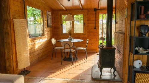 a room with a table and chairs in a cabin at Casa Mocha by RentalsPro - Vourvourou Halkidiki in Vourvourou