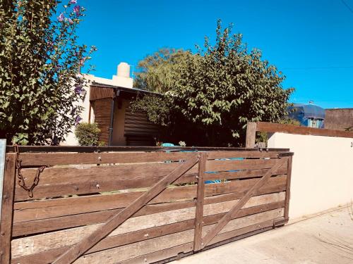 a wooden fence in front of a house at Casita de Noe in Tandil