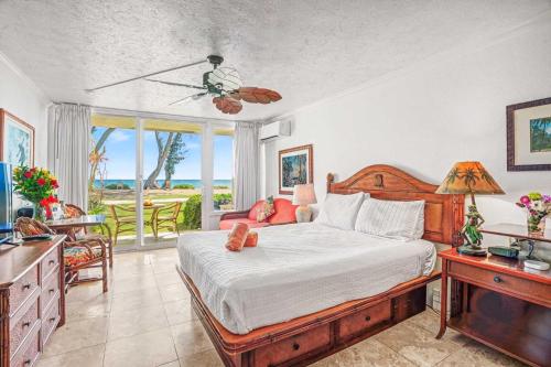 a bedroom with a bed and a table with a desk at Islander on the Beach 131 in Kapaa