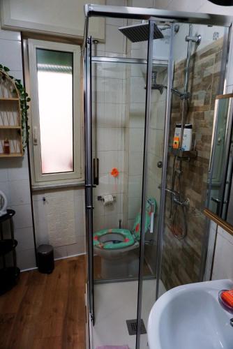 a bathroom with a shower and a sink at Nice room with private bathroom in Ercolano
