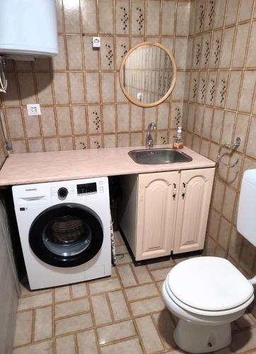 a bathroom with a washing machine and a sink at La Caserma -The Barracks in Bobbio Pellice