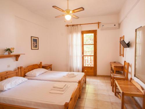 a bedroom with two beds and a window at ELIZA Skiathos in Skiathos Town
