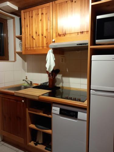 a kitchen with a sink and a stove top oven at Les chalets d Evian in Évian-les-Bains