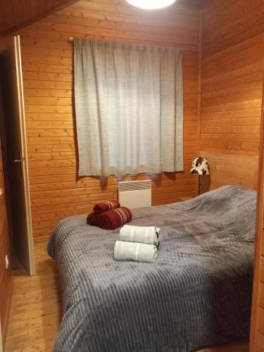 a bedroom with a bed with two towels on it at Les chalets d Evian in Évian-les-Bains
