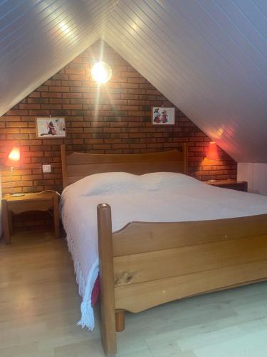 a bedroom with a large bed in a attic at Ici c'est chouette in Vaudricourt