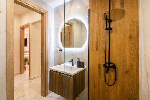 a bathroom with a sink and a mirror at Almond Jacuzzi Suites - Private Indoor Jacuzzi - Self Check-In - Free & Easy Street Parking in Thessaloniki