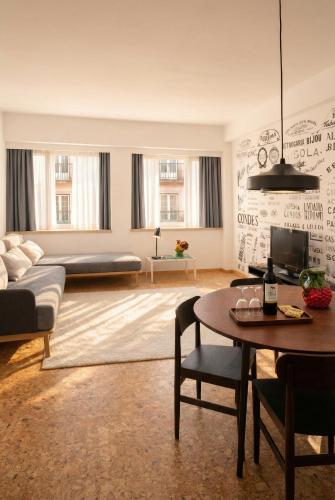 a living room with a couch and a table at The Lisbonaire Apartments in Lisbon