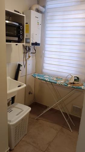 a hospital room with a table in front of a window at Chillan Centro in Chillán