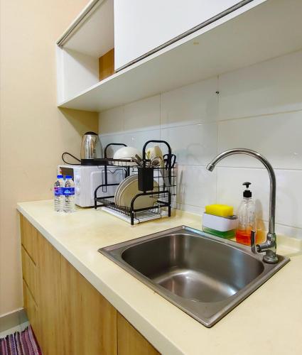 a kitchen counter with a sink in a kitchen at Studio at Mesahill Nilai by D'KAY HOMES with Mall, near USIM KLIA in Nilai