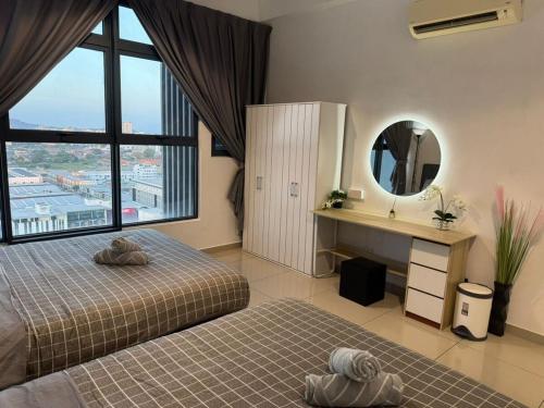 a bedroom with two beds and a large window at Atlantis Residences by UVM Stay -4 Pax in Malacca