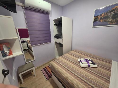 a small bedroom with a bed and a chair at Casa Atocha 1913 Apartamento Histórico con Encanto in Madrid