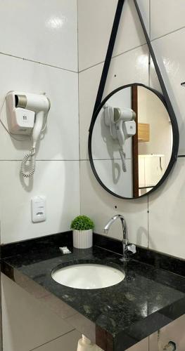 a bathroom with a sink and a mirror at Dunas residence casa 04 in Santo Amaro