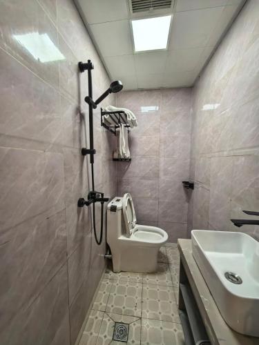 a bathroom with a shower and a toilet and a sink at 木子酒店 in Nanjing