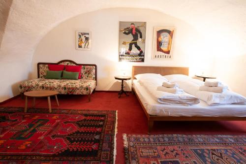 a living room with a bed and a couch at Ferienwohnung Ottmanach Josefhof in Pischeldorf