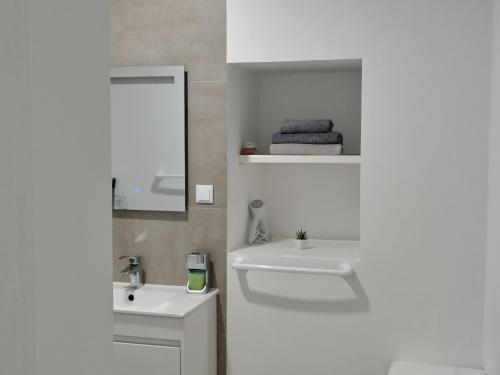 a white bathroom with a sink and a mirror at Apartment in Semeador 1 in Portalegre
