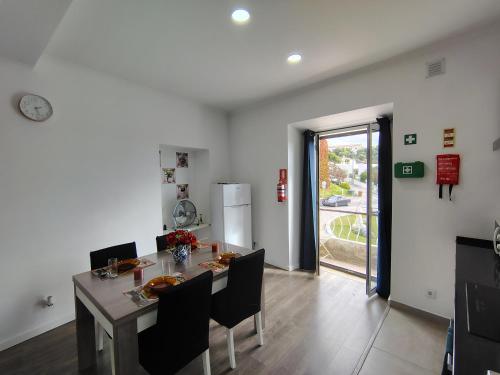 a dining room with a table and chairs and a refrigerator at Apartment in Semeador 1 in Portalegre