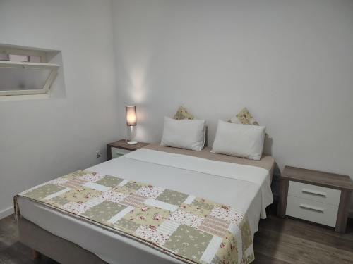 a bedroom with a bed with a quilt on it at Apartment in Semeador 1 in Portalegre